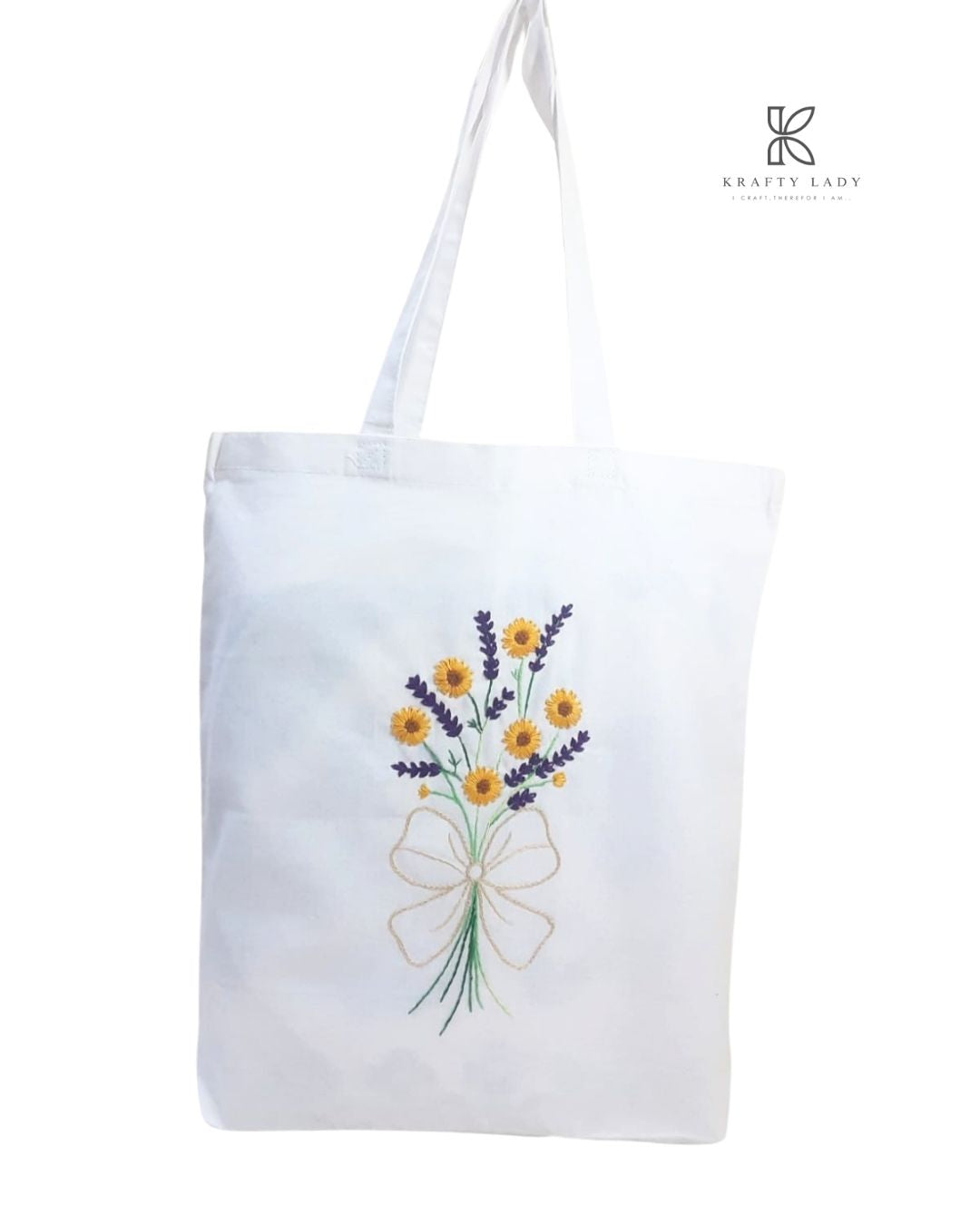 White tote bag with floral embroidery on a white background