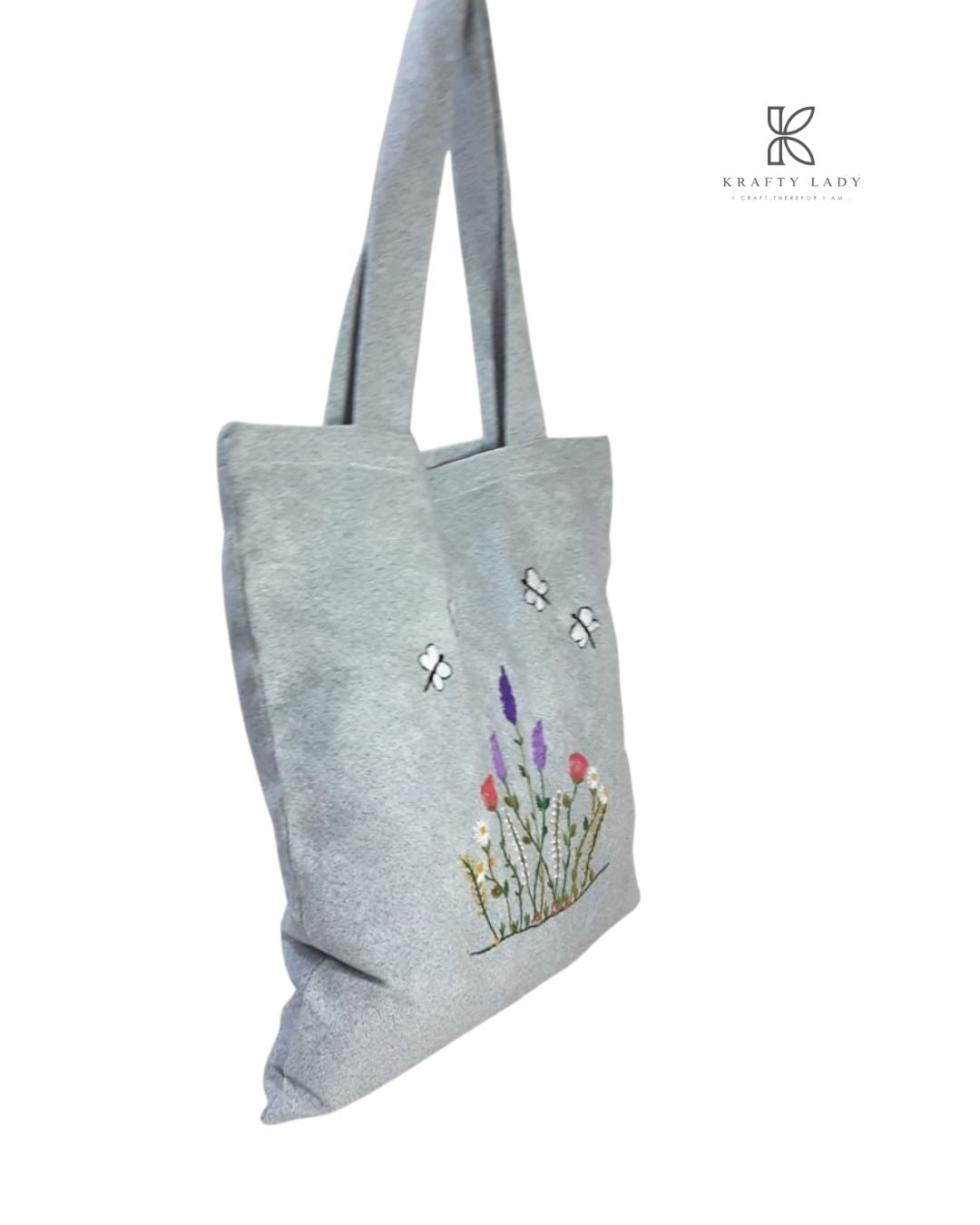 Gray tote bag with floral and insect embroidery