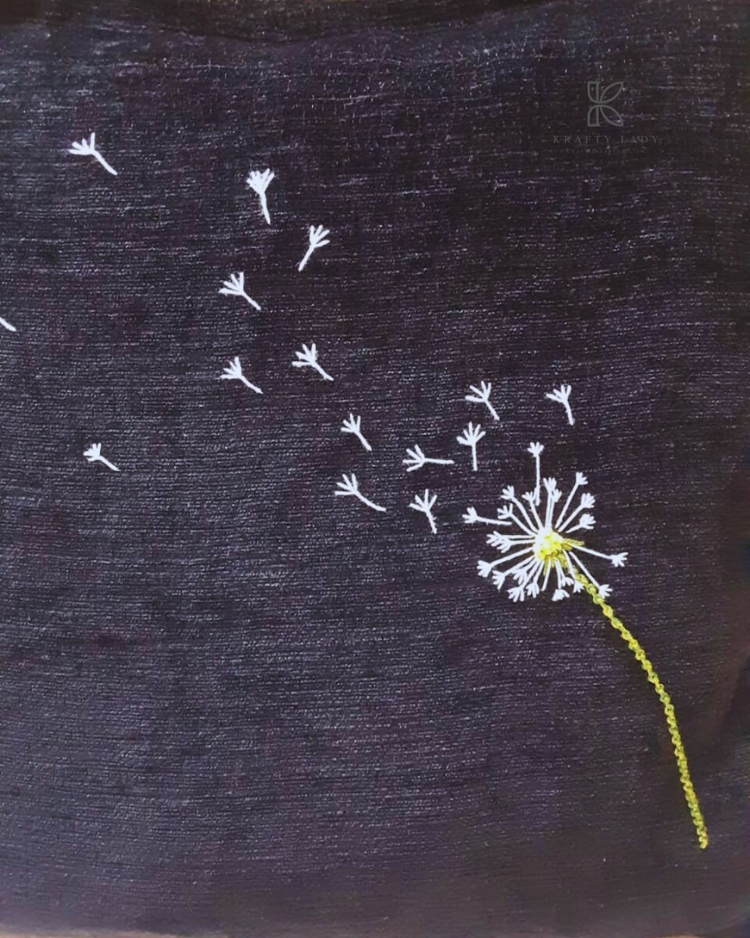 Black tote bag with dandelion design