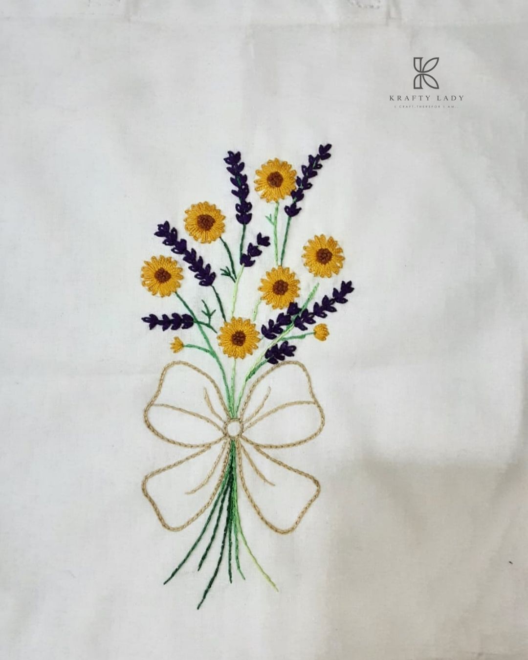 White tote bag with floral embroidery on a white background