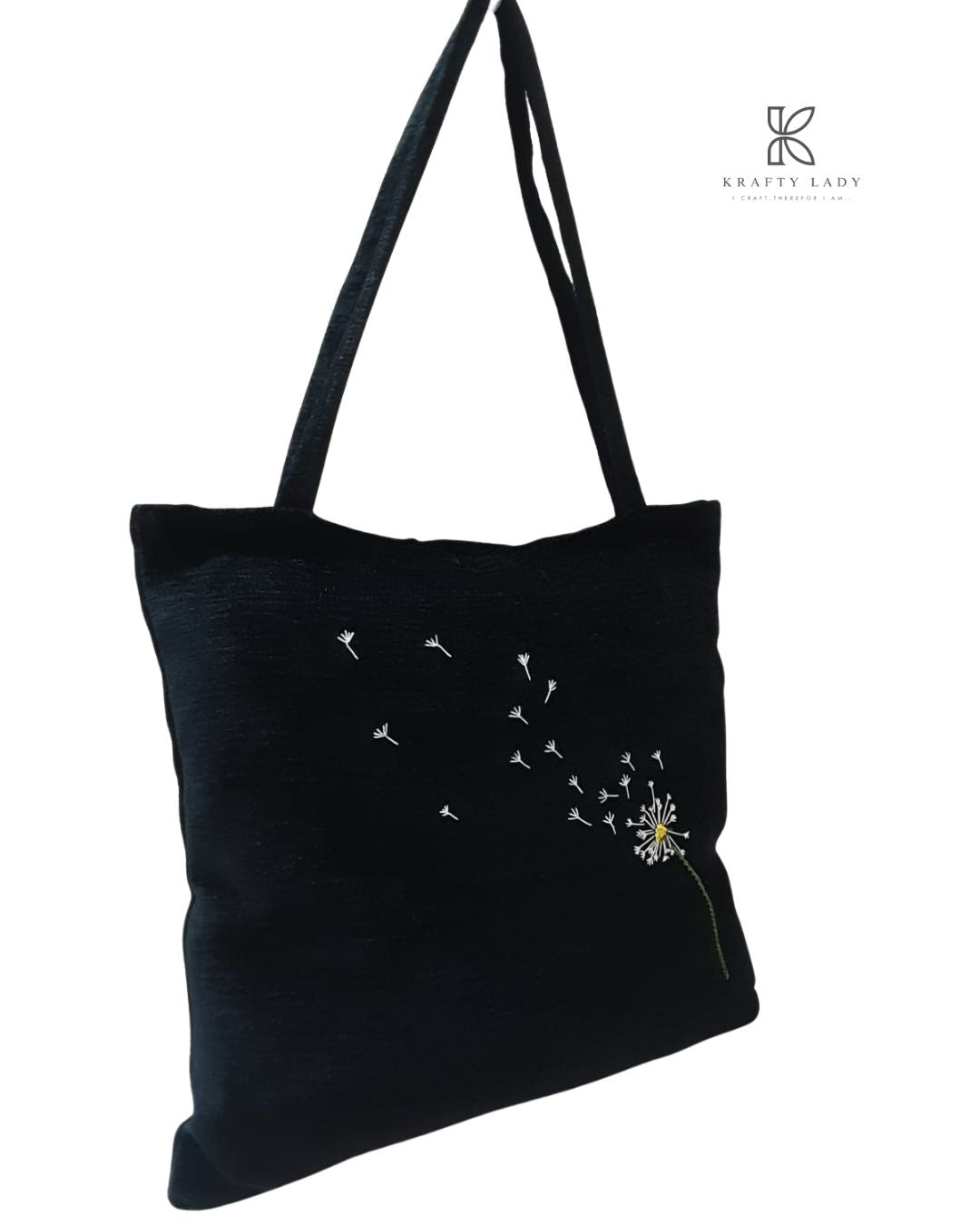 Black tote bag with dandelion design