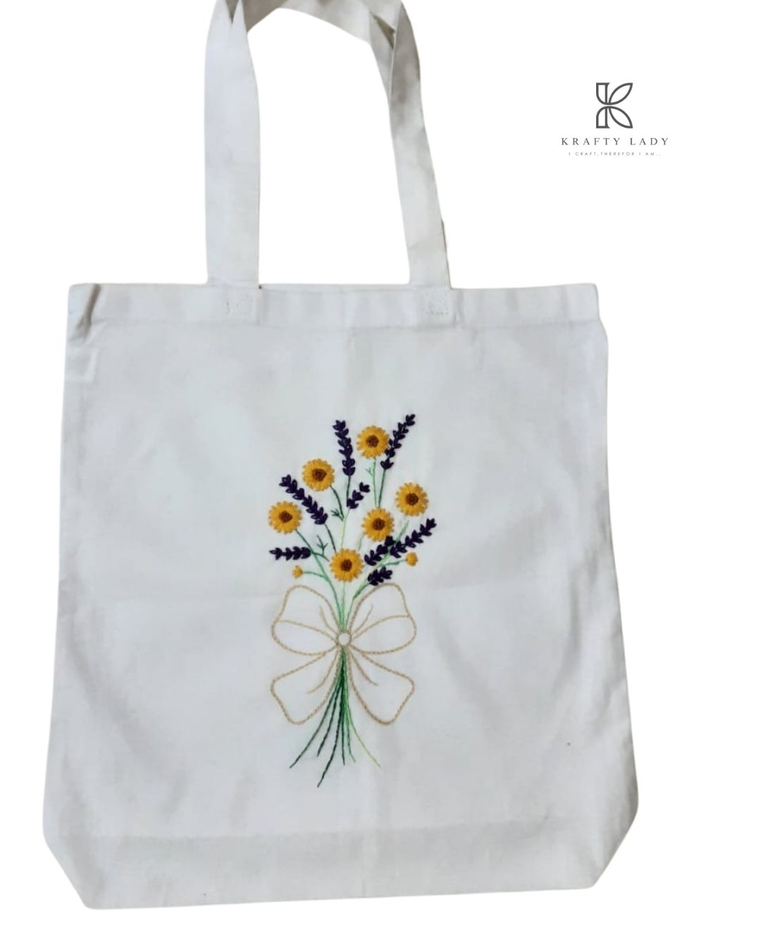 White tote bag with floral embroidery on a white background
